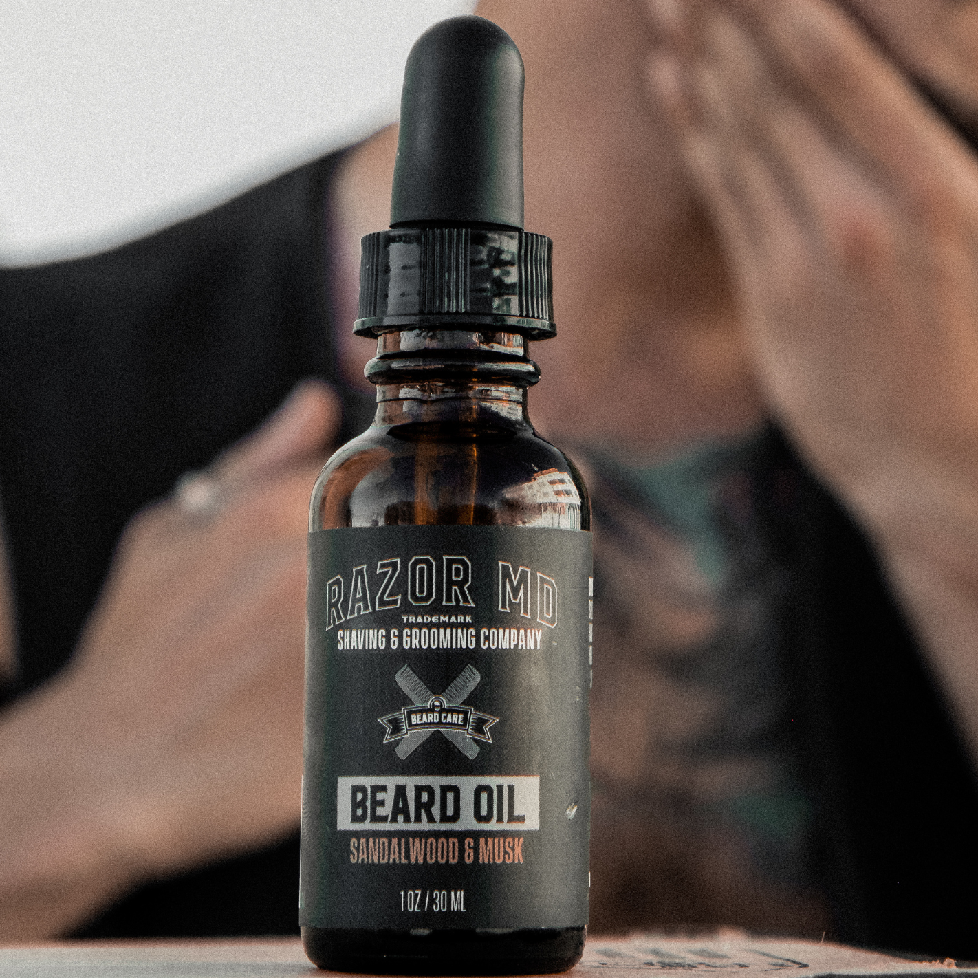 Bottle of RAZOR MD beard oil with a blurred background